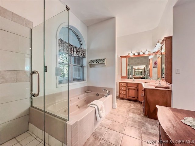 bathroom with independent shower and bath, vanity, and tile patterned floors