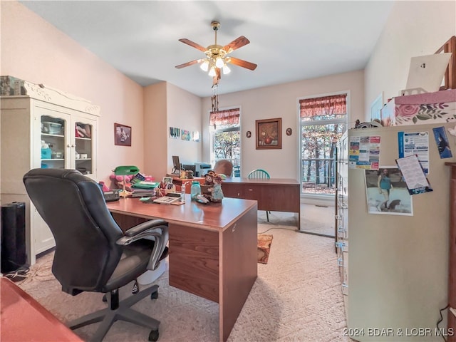 home office featuring ceiling fan and light carpet