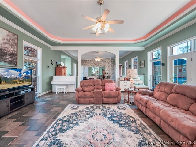 living room with ceiling fan and crown molding