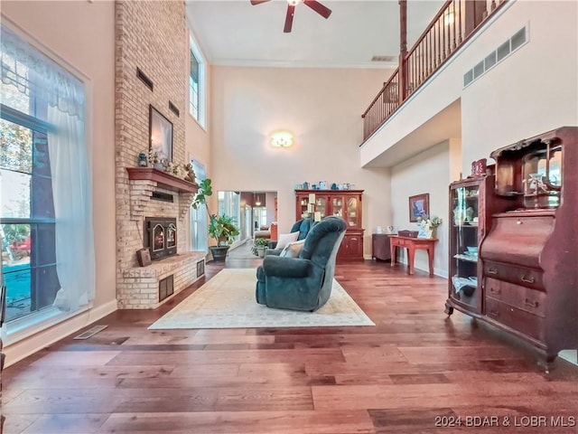293 Windsong, Camdenton, MO 65020 - living area with a towering ceiling, a ceiling fan, a brick fireplace, and wood finished floors