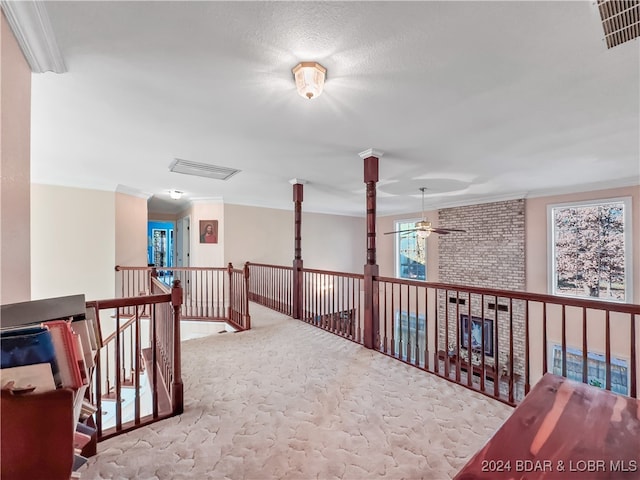 hall with light carpet and crown molding