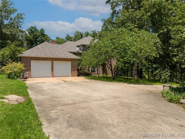 293 Windsong, Camdenton, MO 65020 - view of front of home with brick siding, concrete driveway, a shingled roof, and an attached garage