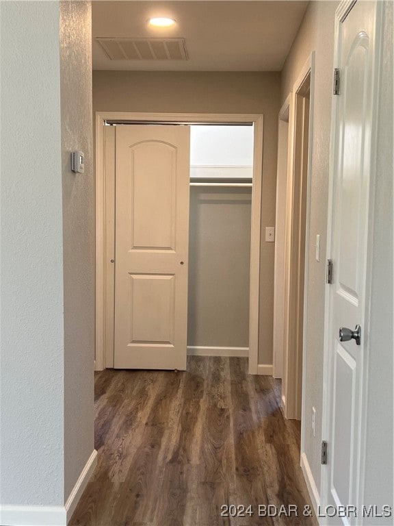 corridor featuring dark hardwood / wood-style flooring