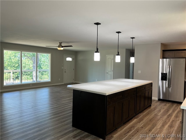 kitchen featuring ceiling fan, dark hardwood / wood-style floors, a kitchen island, stainless steel fridge with ice dispenser, and pendant lighting