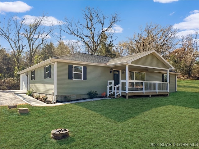 view of front of property with a front yard and an outdoor fire pit