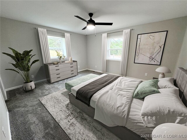 bedroom featuring carpet, multiple windows, and ceiling fan