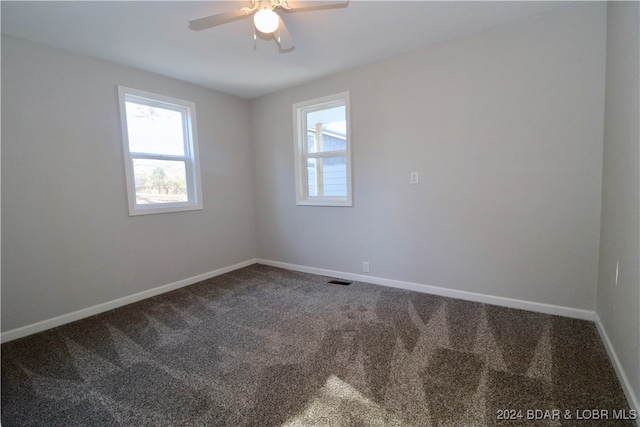 carpeted spare room with ceiling fan