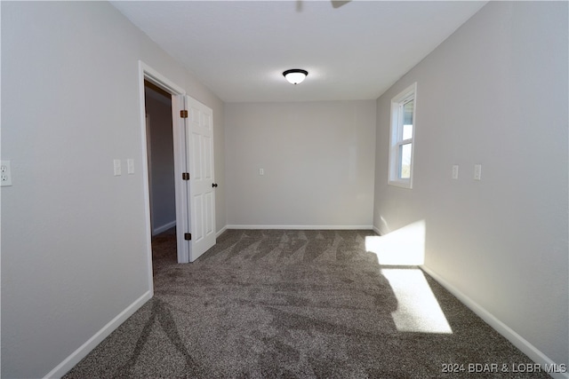 empty room with dark carpet