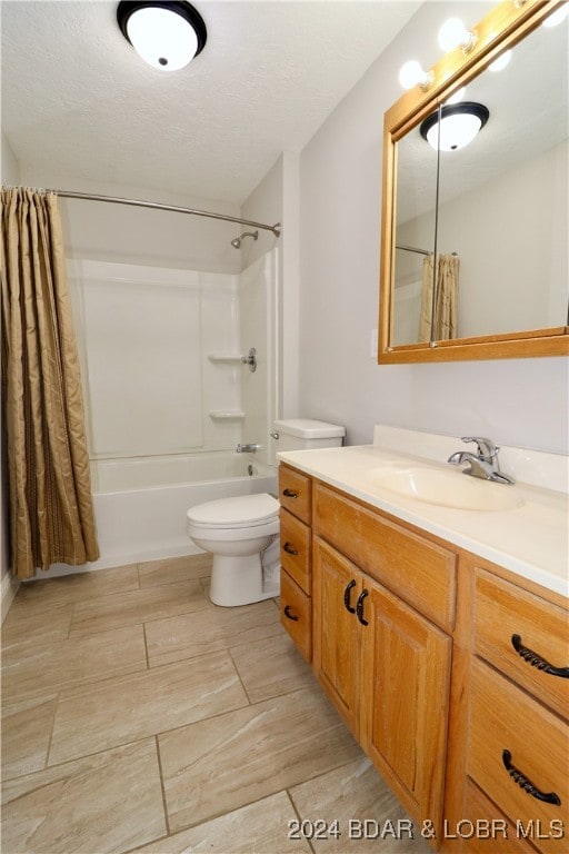 full bathroom with vanity, toilet, a textured ceiling, and shower / bath combination with curtain