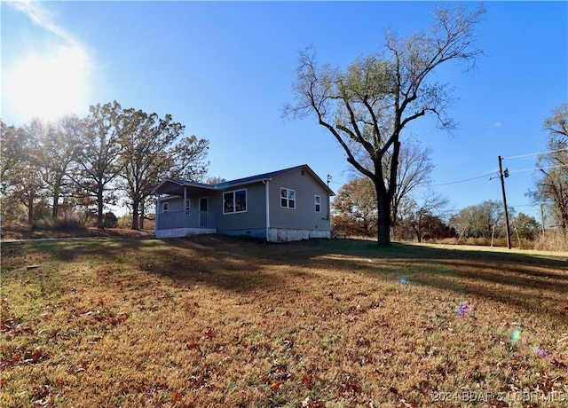 261 Buffalo Linn Creek Rd, Macks Creek, MO 65786 - view of property exterior featuring a porch and a yard