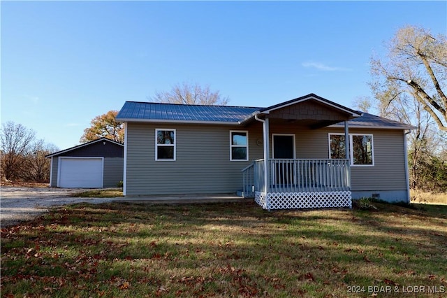 261 Buffalo Linn Creek Rd, Macks Creek, MO 65786 - ranch-style house with covered porch, a front lawn, an outbuilding, gravel driveway, and a detached garage
