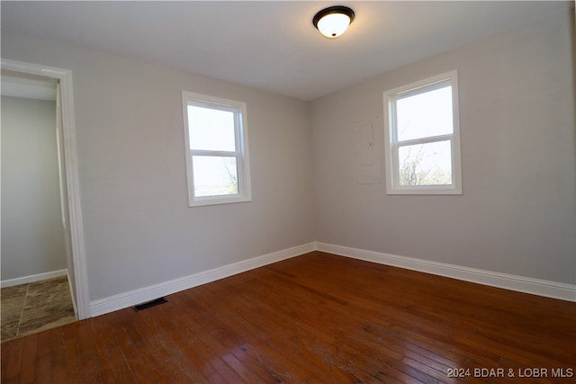 empty room featuring dark hardwood / wood-style flooring