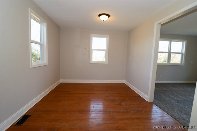 empty room featuring dark hardwood / wood-style flooring