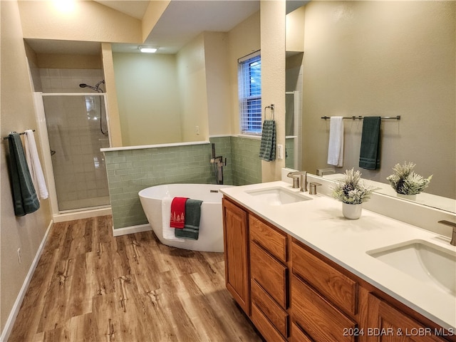 bathroom with vanity, plus walk in shower, lofted ceiling, and hardwood / wood-style flooring