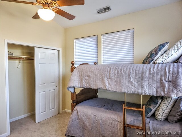 carpeted bedroom featuring ceiling fan and a closet