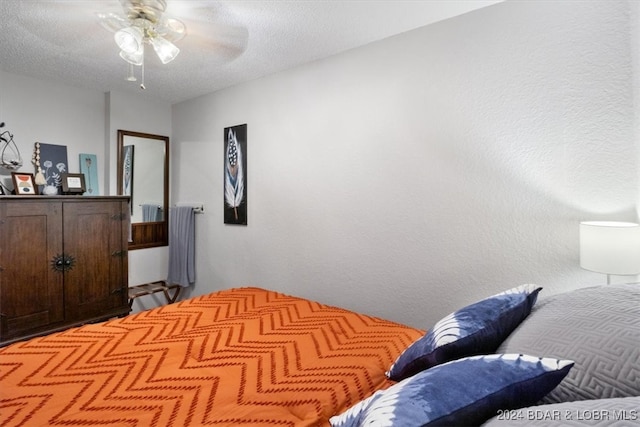 150 Southwood Shores Pl Bldg 159Unit Unit 1B, Lake Ozark, MO 65049 - bedroom featuring a textured ceiling and a ceiling fan