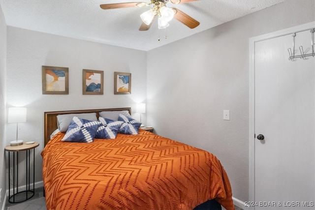 150 Southwood Shores Pl Bldg 159Unit Unit 1B, Lake Ozark, MO 65049 - bedroom featuring baseboards, a textured ceiling, and a ceiling fan