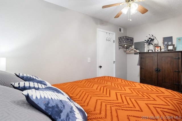 150 Southwood Shores Pl Bldg 159Unit Unit 1B, Lake Ozark, MO 65049 - bedroom with a textured ceiling and ceiling fan