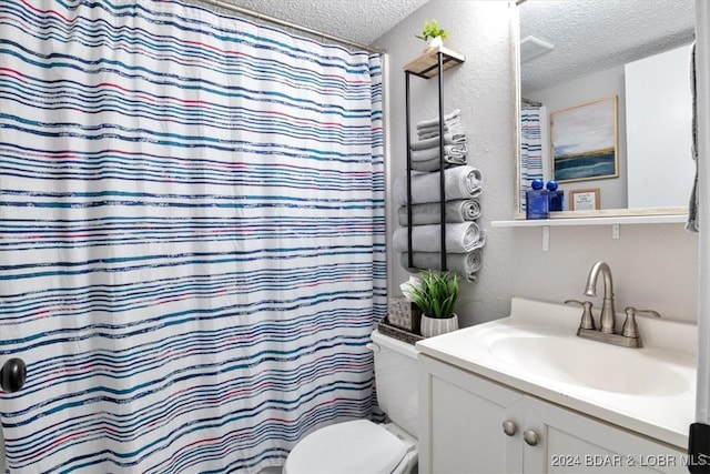 150 Southwood Shores Pl Bldg 159Unit Unit 1B, Lake Ozark, MO 65049 - bathroom featuring a textured ceiling, toilet, vanity, a textured wall, and curtained shower