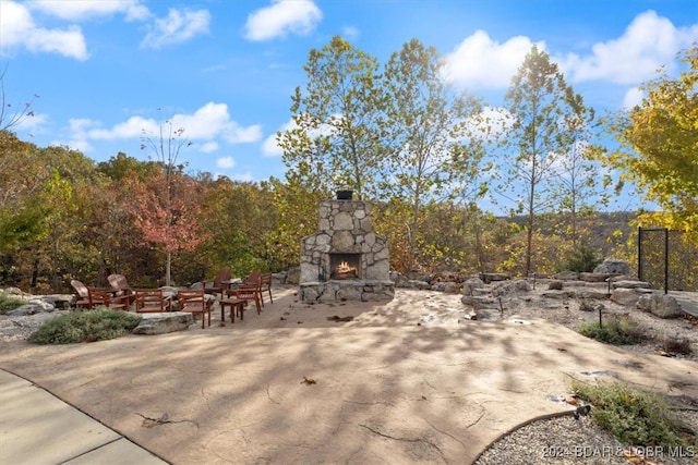 view of patio / terrace with an outdoor stone fireplace