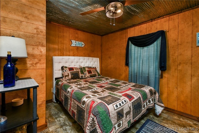 bedroom with wood walls and ceiling fan