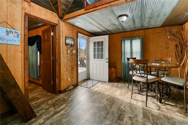 interior space with wood-type flooring and wooden walls