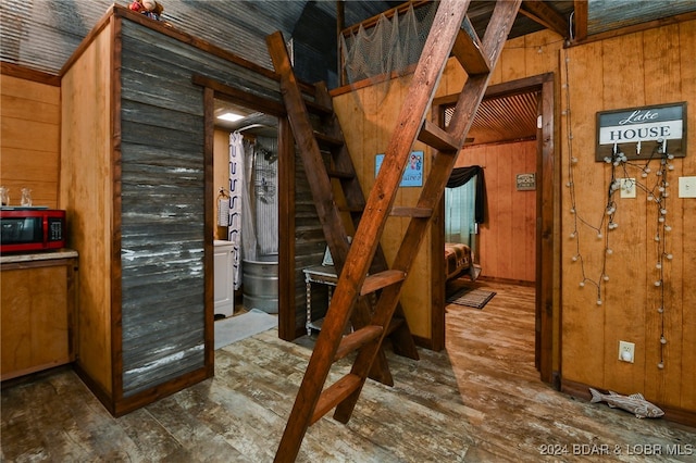 interior space with wooden walls and dark hardwood / wood-style floors