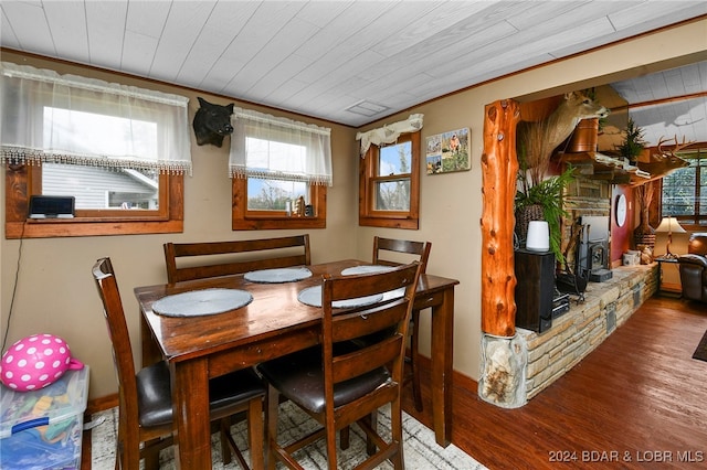 dining area with plenty of natural light, hardwood / wood-style flooring, and wood ceiling