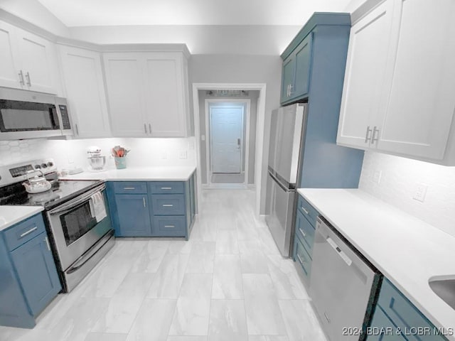 kitchen with backsplash, white cabinetry, stainless steel appliances, and blue cabinets