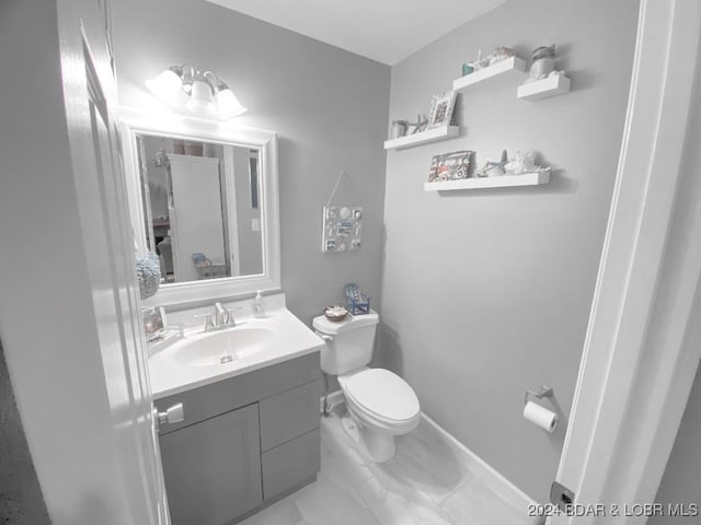 bathroom featuring vanity and toilet