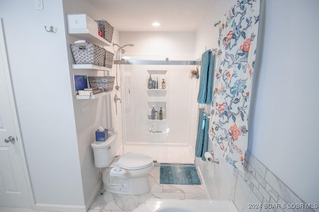 bathroom featuring toilet and walk in shower