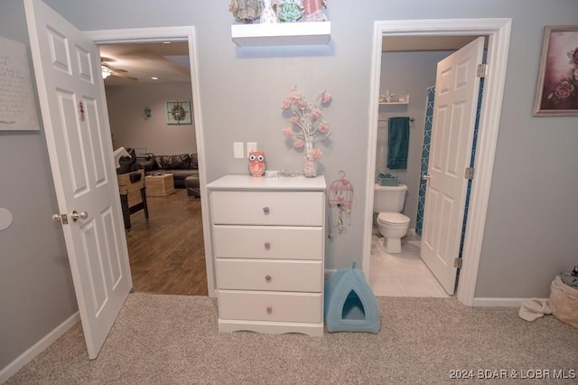 bathroom featuring tile patterned flooring, toilet, and ceiling fan