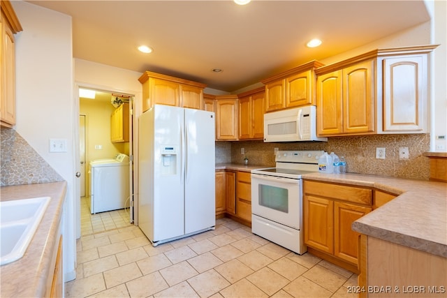 kitchen featuring washer and clothes dryer, sink, white appliances, and decorative backsplash