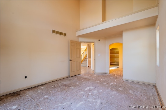 unfurnished room with a high ceiling