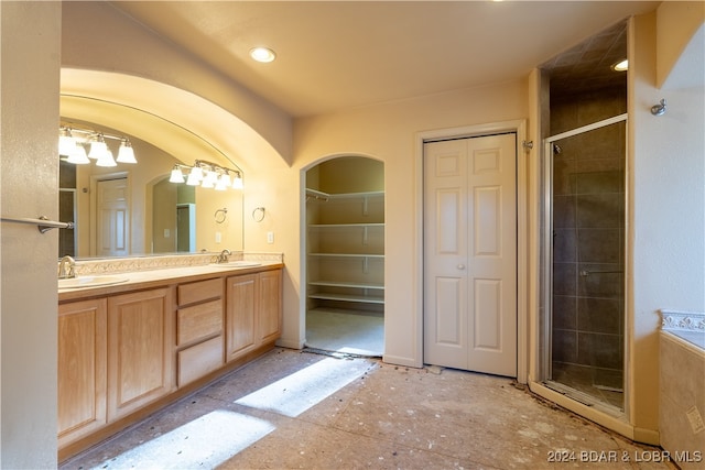 bathroom featuring vanity and a shower with shower door