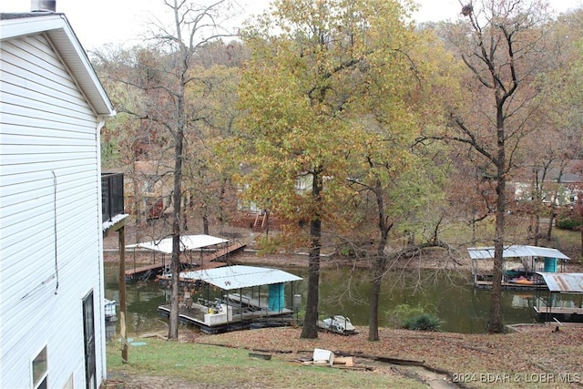 view of yard featuring a boat dock and a water view