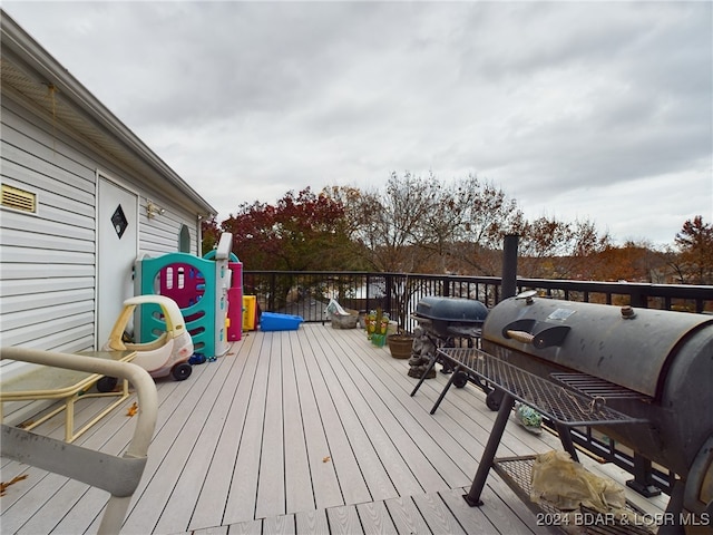 wooden terrace featuring area for grilling