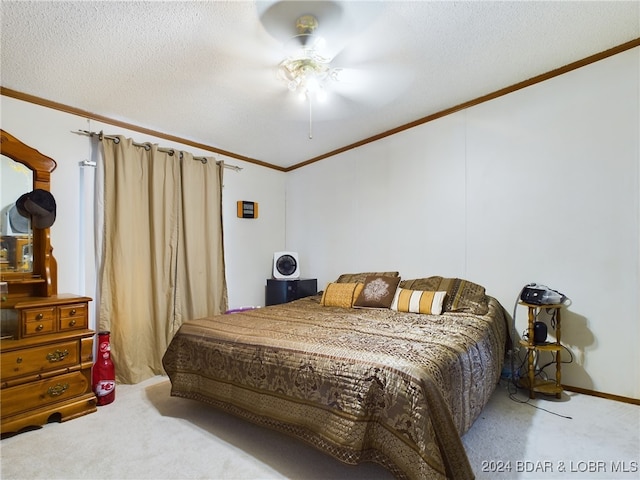 bedroom with carpet floors, ornamental molding, a textured ceiling, and ceiling fan