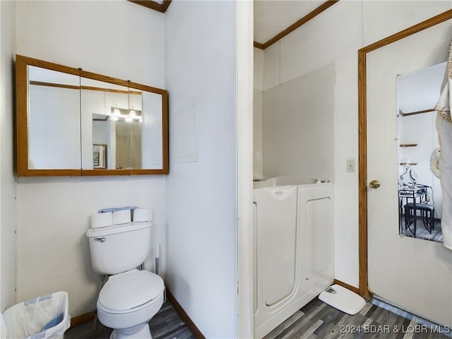 bathroom with hardwood / wood-style floors and toilet