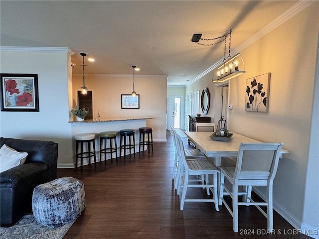 dining room with ornamental molding and dark wood-type flooring