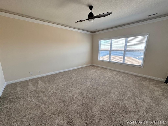 carpeted empty room with a textured ceiling, ornamental molding, and ceiling fan