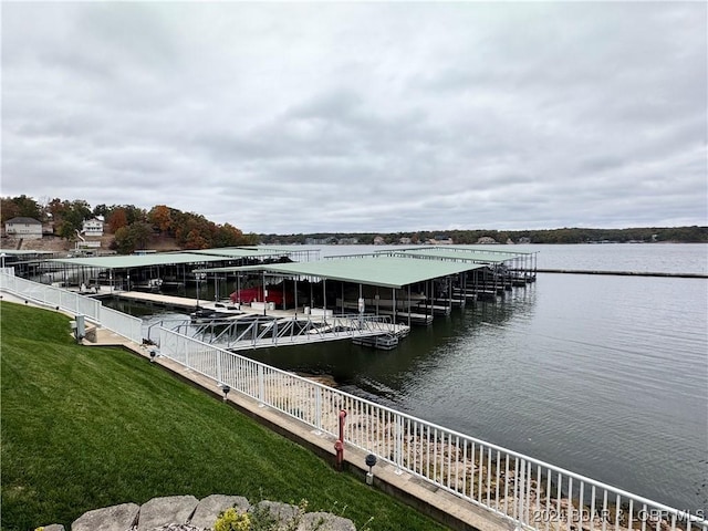 dock area featuring a water view and a lawn