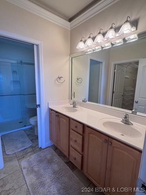 bathroom with toilet, a shower, tile patterned floors, ornamental molding, and vanity