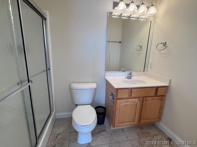 bathroom featuring toilet, walk in shower, and vanity