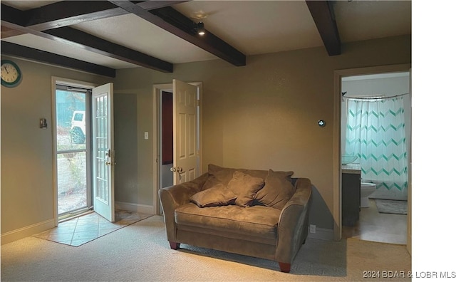 carpeted living room with beam ceiling and baseboards