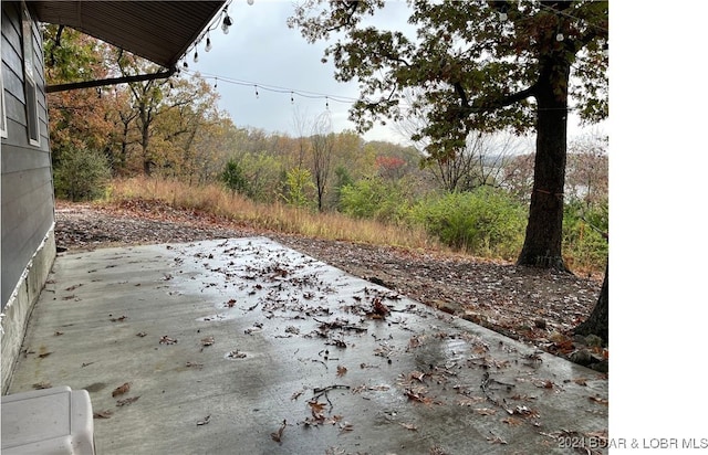 view of patio with a view of trees