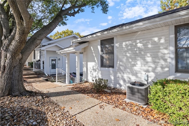 property entrance featuring central AC unit