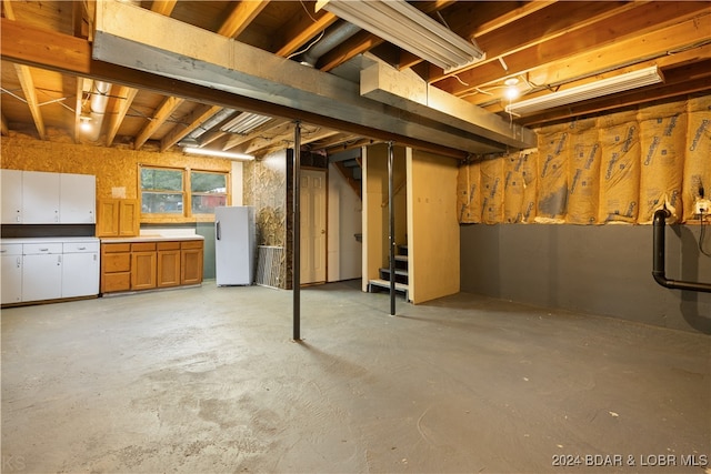 basement with white refrigerator