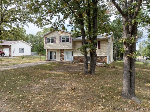 tri-level home with a front yard