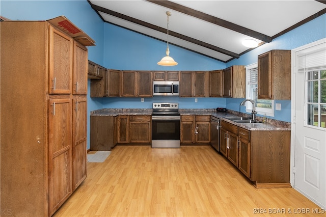 kitchen featuring stainless steel appliances, light hardwood / wood-style floors, sink, beam ceiling, and hanging light fixtures